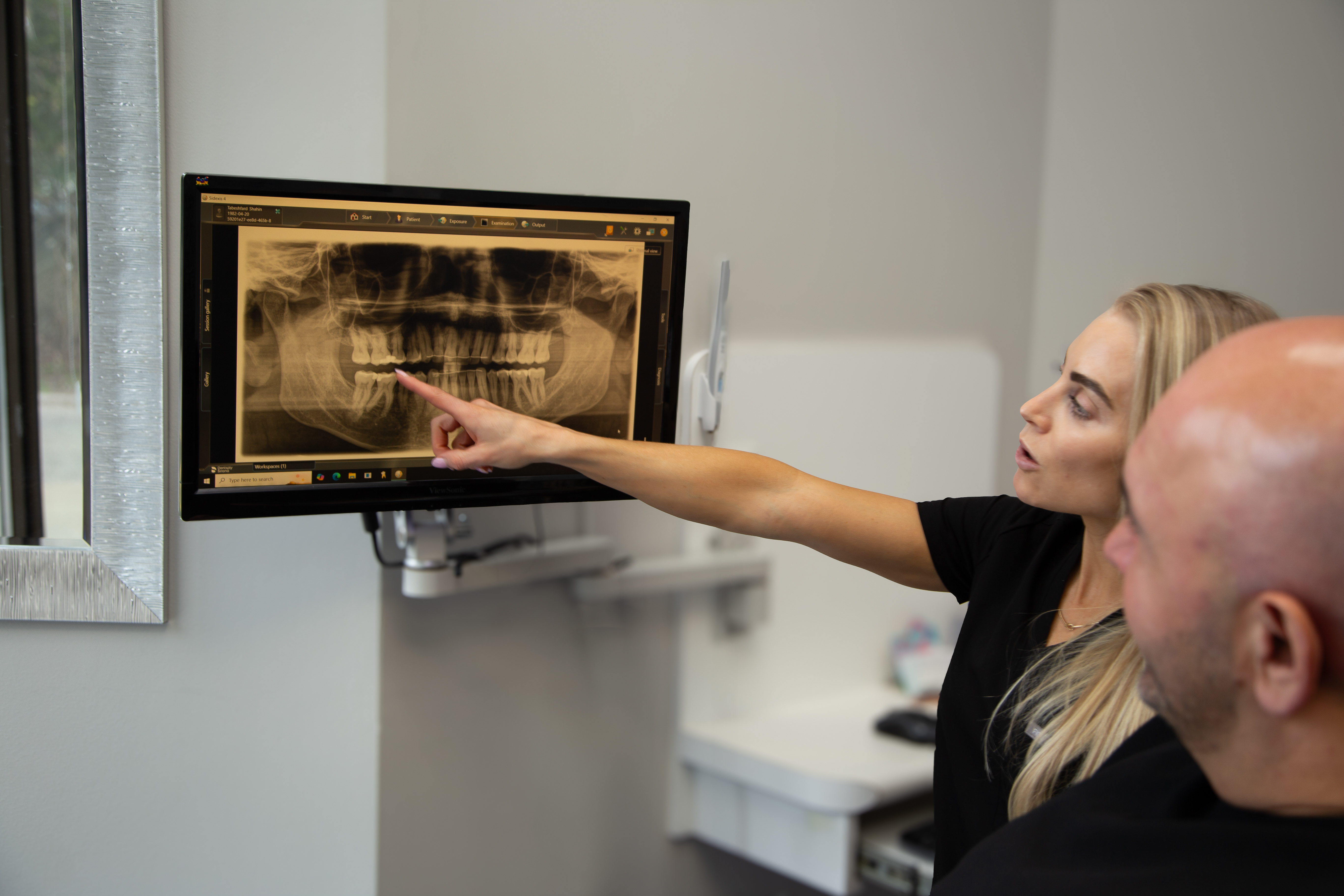 Dr. Aly reviewing X-rays with a patient